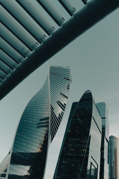 Low angle view of glass skyscrapers framed by concrete beam