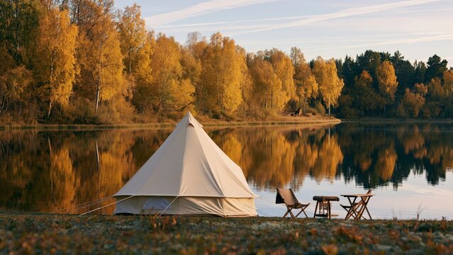 Nature - Camping tent by the lake in autumn landscape