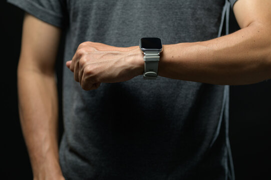 Close-up of a person checking time on smart watch in casual attire