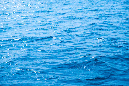 Top view of deep blue sea water surface with small ripples, aerial drone shot of turquoise ocean texture at island , abstract nature background	