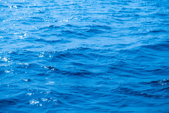 Top view of deep blue sea water surface with small ripples, aerial drone shot of turquoise ocean texture at island , abstract nature background	