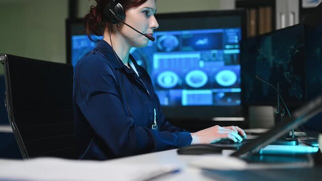Female cybersecurity analyst working in a futuristic command center. She uses interactive screens and a headset to manage global data networks.