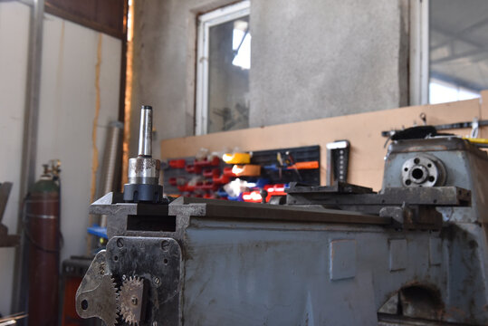 Metal collet chuck holder on industrial lathe in a workshop