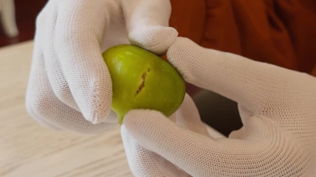 Hand Tapping and Breaking Open Fresh Fig Revealing Red Interior Close-Up