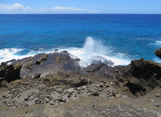 Water spraying after waves hit rocks at the Halona Blowhole in Oahu, Hawaii © Karlysia