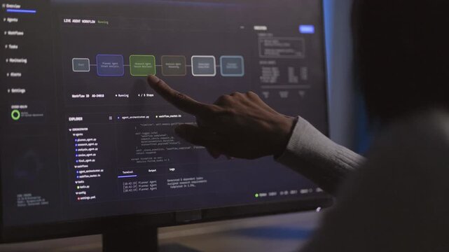Technical Trainer points toward projected computer software workflow, explaining digital process through clear visual technology communication, with professional workflow communication.