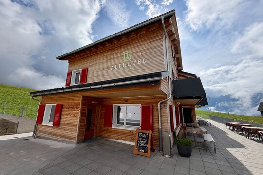Biel, Switzerland - September 11, 2026: Alphotel Biel-Kinzig, a traditional wooden mountain hotel and restaurant in the Uri Alps, offering accommodation and dining for hikers and alpine tourists.