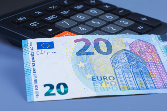 Twenty euro banknote on black calculator keyboard. Finance, budget planning, tax calculation and economy concept for business.
