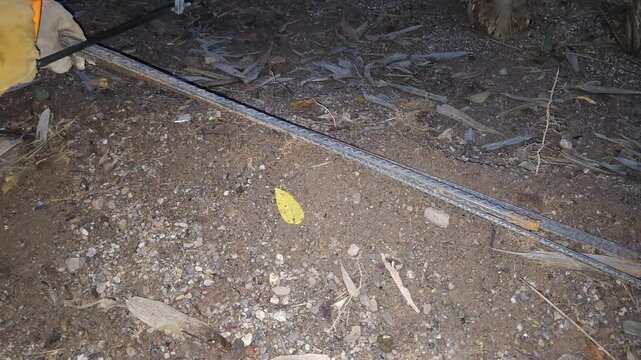 Cutting Metal Rods with Hacksaw Outdoors