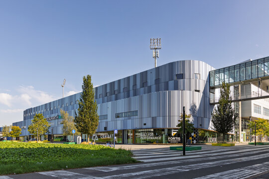 Sittard, Netherlands - October 04, 2026: Exterior view of the Fortuna Sittard football stadium complex with floodlights, shops and sports center on a bright sunny day.