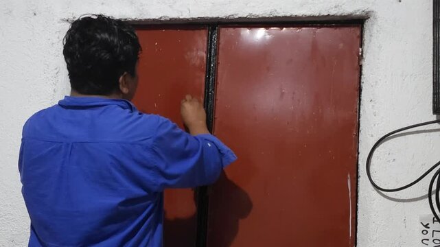 Wiping Down Double Window Frame with Cloth by Hand