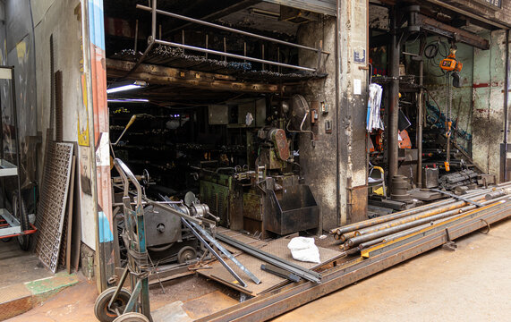 Authentic metal fabrication workshop and machinery in an urban alley   