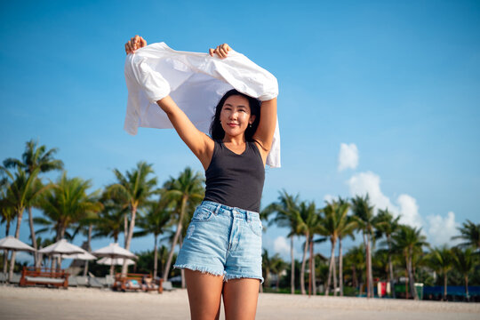 Mindful woman connecting with nature and feeling the breeze during a peaceful morning on the beach