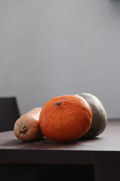 Different pumkins on walnut wood table