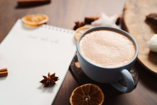 Hot chocolate in a blue cup with natural christmas decorations