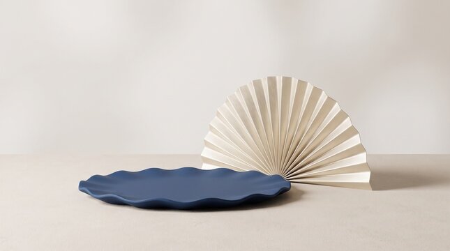 Minimalist ceramic plate with blue scalloped edge and decorative fan