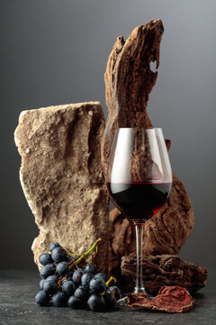 Red wine with stone, dried snags, and blue grapes.