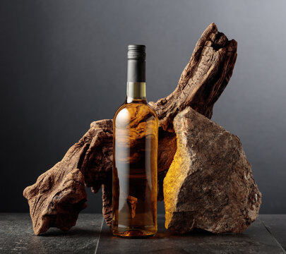 White wine with old snag and a piece of granite rock.