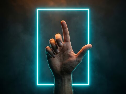 A human hand points at a neon frame, suggesting interactive technology.