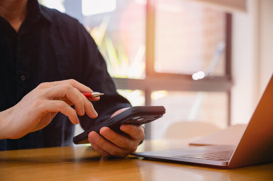 Social media marketing concept. Businessman hand using smartphone typing, chatting conversation in chat box icons pop up