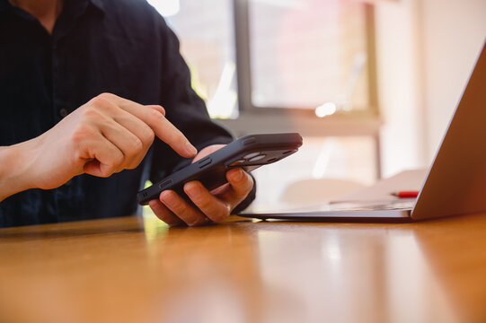 Social media marketing concept. Businessman hand using smartphone typing, chatting conversation in chat box icons pop up