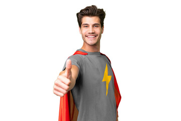 Young handsome caucasian man over isolated background in superhero costume with thumb up © luismolinero