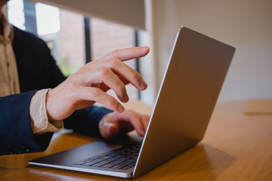 Business marketing Social media marketing concept. Businessman hand using computer laptop typing working in modern home office.