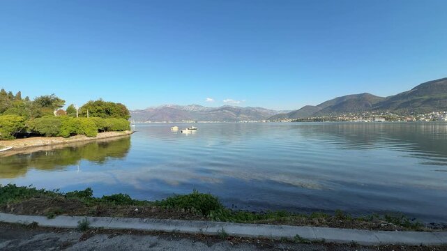 Calm Coastal Bay with Mountains and Small Boats