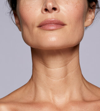 close up shot of mature woman neck, chin, and lower face showing skin texture, subtle wrinkles, freckles, and natural lips for skincare, anti aging cosmetic treatment, and dermatological research