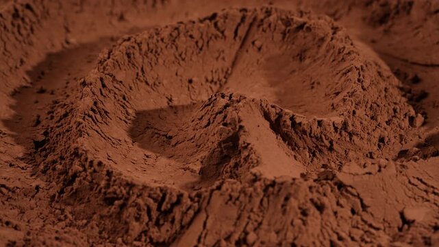 Top view of dry cocoa or ground coffee powder heap in wave lines, rotates. Macro view of brown chocolate powder ingredients for baking recipe and culinary design