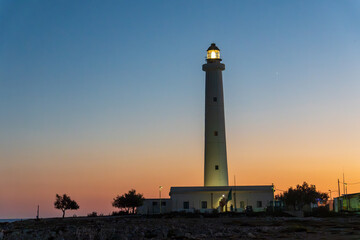Breathtaking view of the emblematic Punta Sottile lighthouse during a dramatic warm sunset on the western tip of Favignana Island, Egadi Islands, Sicily, Italy.  Mediterranean sea by sunset © ANADEL