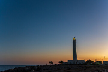 Breathtaking view of the emblematic Punta Sottile lighthouse during a dramatic warm sunset on the western tip of Favignana Island, Egadi Islands, Sicily, Italy.  Mediterranean sea by sunset © ANADEL