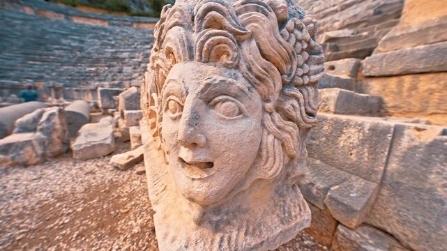 Myra in Antalya, Turkiye showcases intricate close-up details of ancient carved face masks and majestic stone relief ruins.