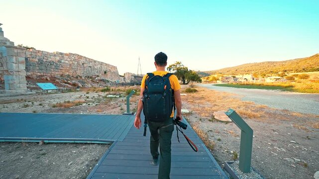 Patara Ancient City in Antalya features a traveler exploring historic ruins with a camera, discovering the rich heritage of the ancient site.