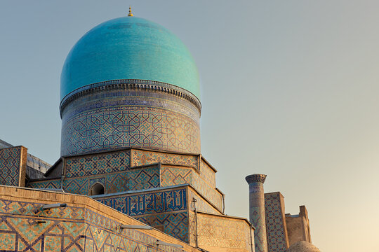Turquoise dome of Tilla Kori Madrasah at Registan Square in Samarkand with intricate geometric tilework. Ideal for travel publications, cultural heritage materials, and architectural reference.