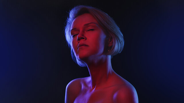 Portrait of fashion real young girl in red neon light in the studio