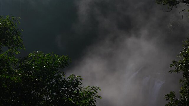 Waterfall Mist Rising Above Tropical Forest Canopy