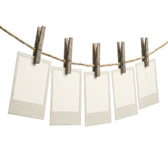 Blank paper cards hanging on a rope with wooden clips © Raja