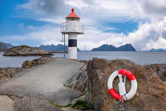 Title:
Coastal lighthouse near Kabelvag with dramatic mountains in the Lofoten Islands, Norway