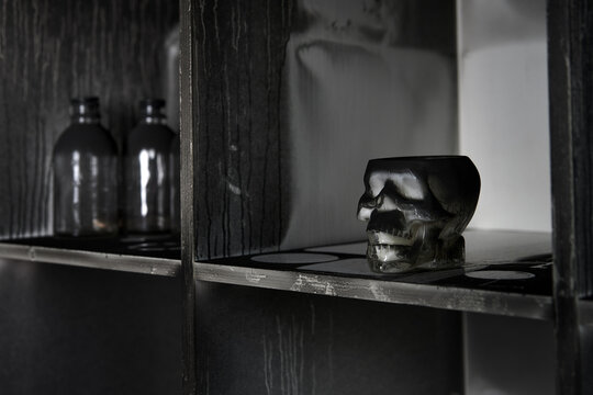 Skull ornament on scorched shelf after fire accident