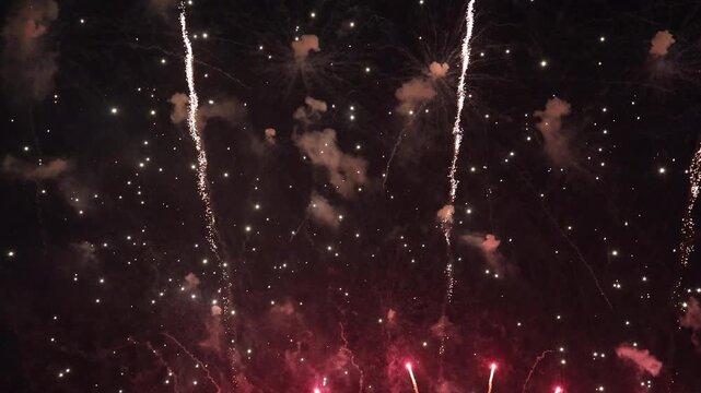 Amazing real beautiful colorful fireworks background on celebration night event for happy new year party or independence day, Abstract Multi color golden firework in the night sky