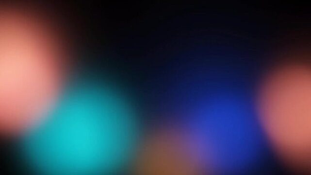 Soft defocused teal amber and blue light patches drifting across dark background