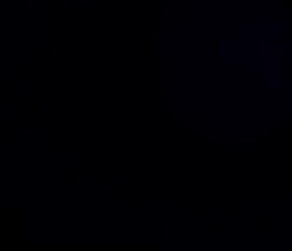 Soft defocused teal amber and blue light patches drifting across dark background