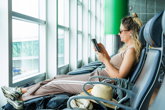 Woman read ebook while waiting in airport lounge