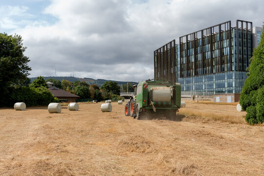 Baler wrapper at work beside modern office building