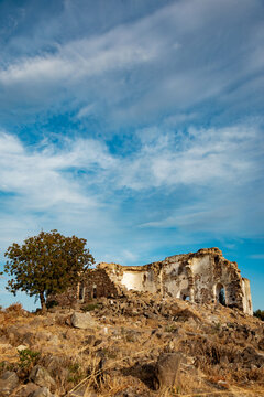 Ancient ruins of Erythrai beneath dramatic blue sky