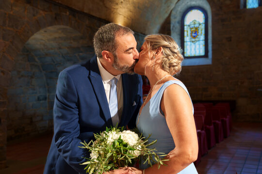 Married couple kiss during civil wedding ceremony