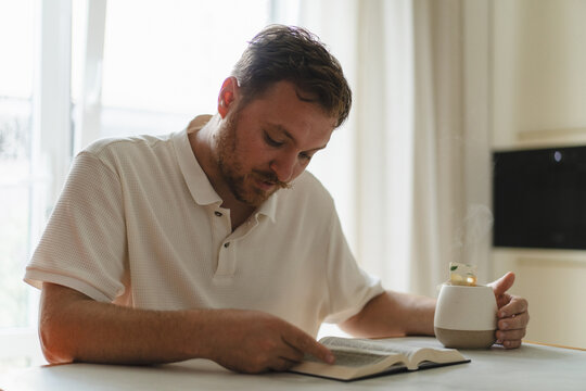 Man read Bible at home with quiet reflection