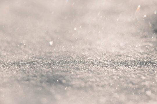 Soft sparkling snow texture with pastel winter bokeh