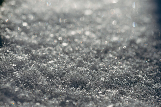 Sparkling snow surface with soft winter bokeh background